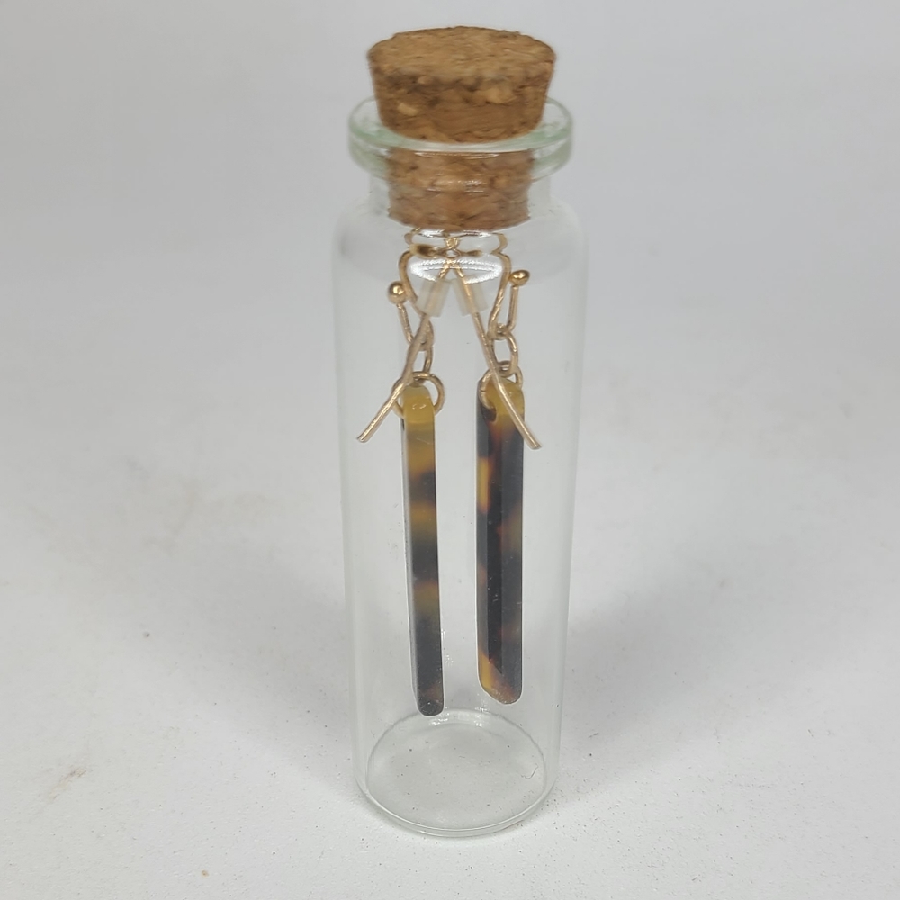 Brown and tan earrings. Dangle in a bottle
